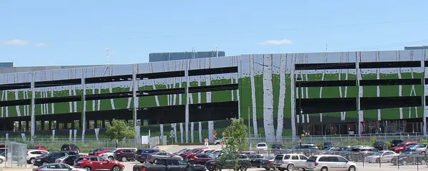 The north side of the Club Regent Casino complex in Winnipeg: its multi-level parkade wrapped in a birch-tree mural, above a full parking lot